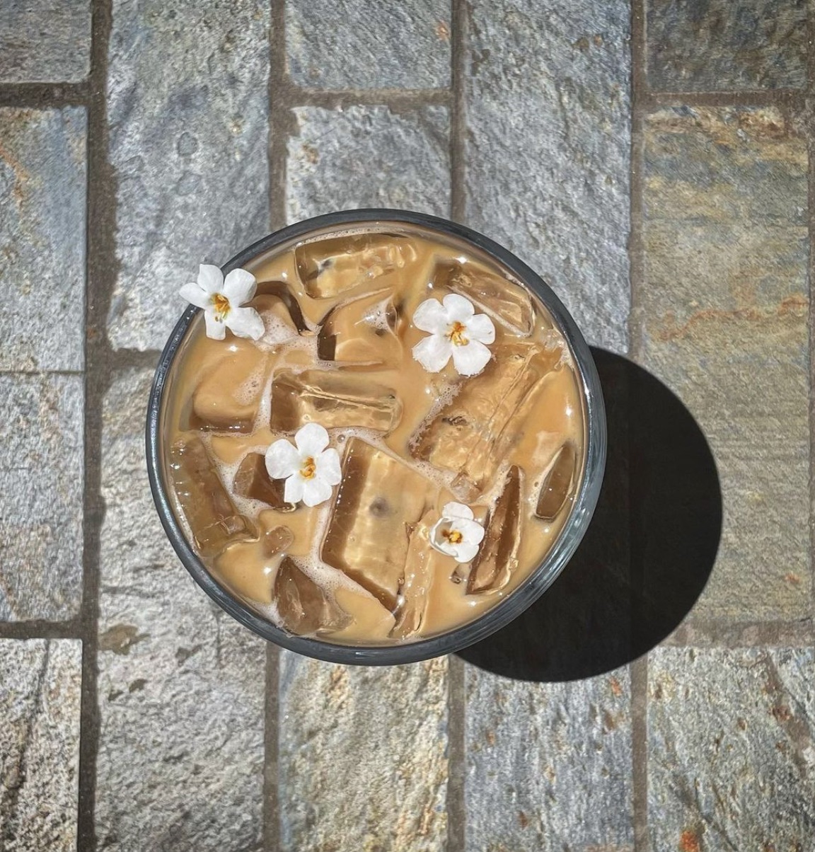 Iced coffee from Quick Fix with small white flowers